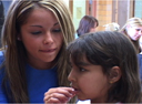 Image of nurse and a child, from Caring Nurses Video